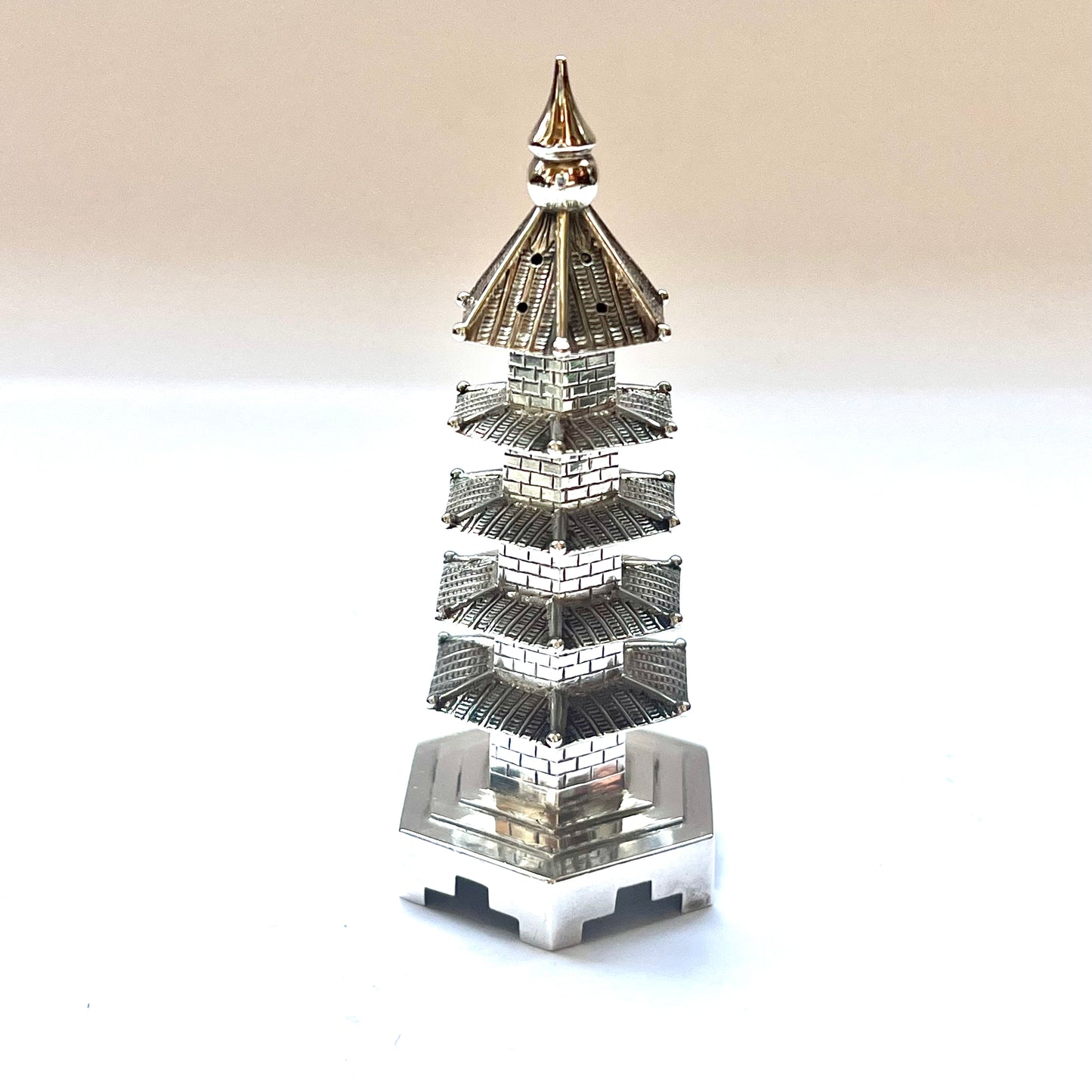 Early 20th century pagoda novelty form pepperette, marks for .900 silver and Wang Hing