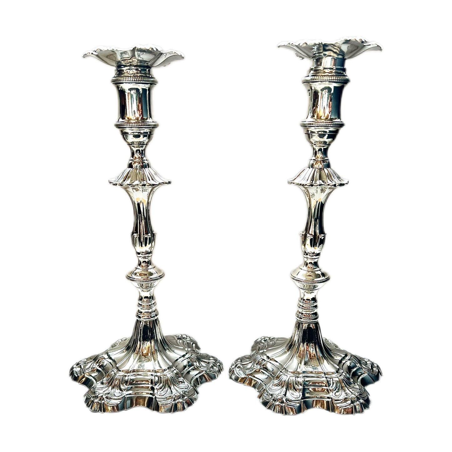 Pair of crested George III sterling silver cast candlesticks by William Cafe, London 1761 and 1762