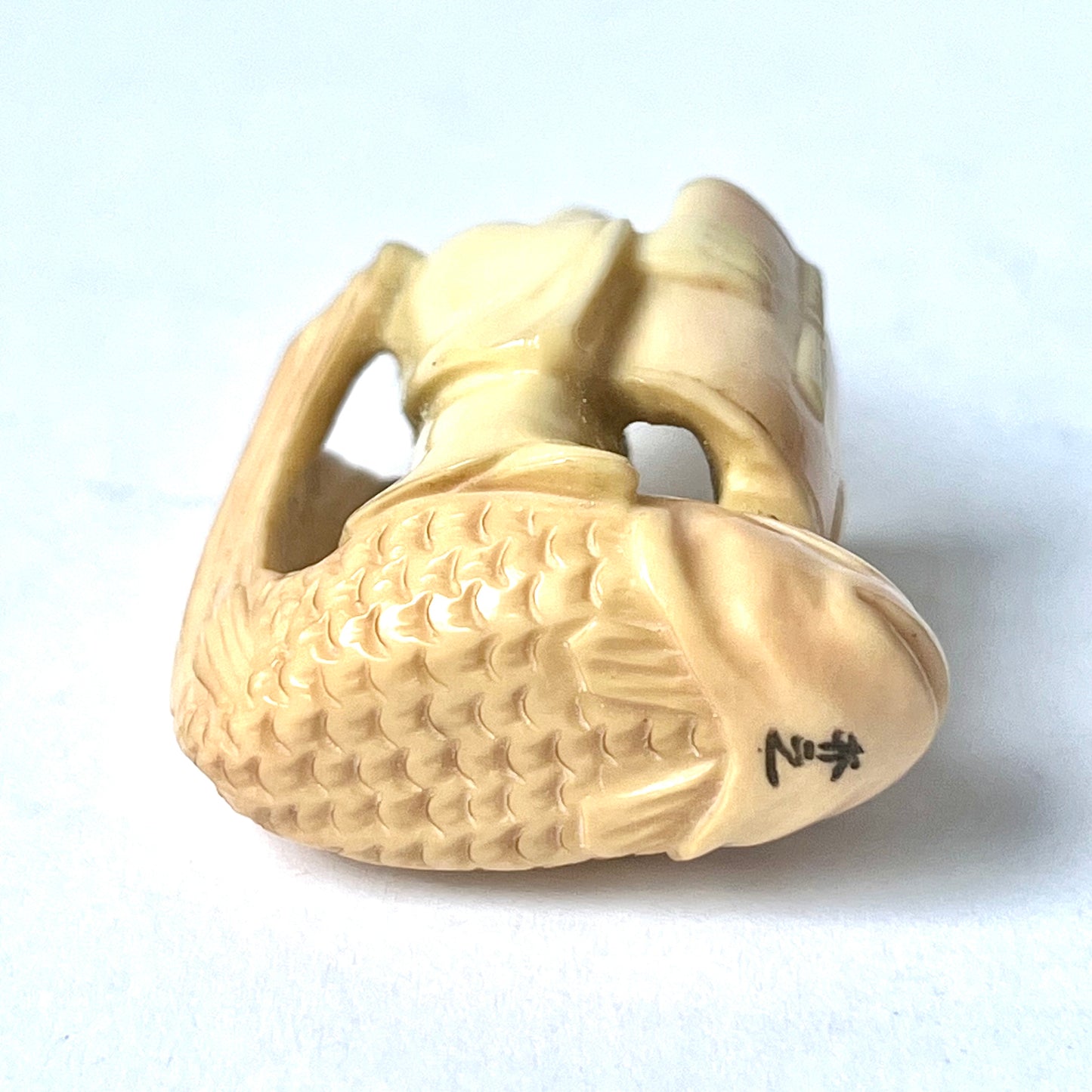 Antique Japanese ivory netsuke of the Taoist immortal Kinko riding on a red carp