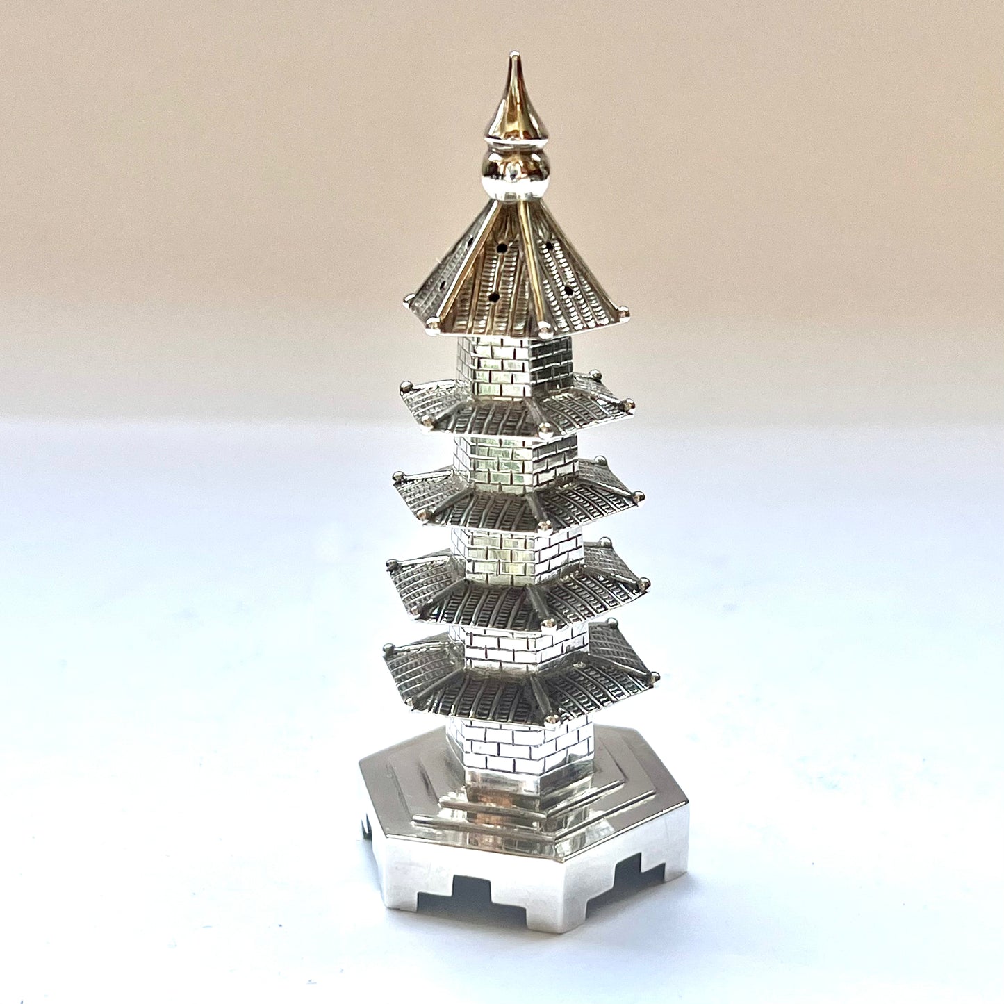 Early 20th century pagoda novelty form pepperette, marks for .900 silver and Wang Hing