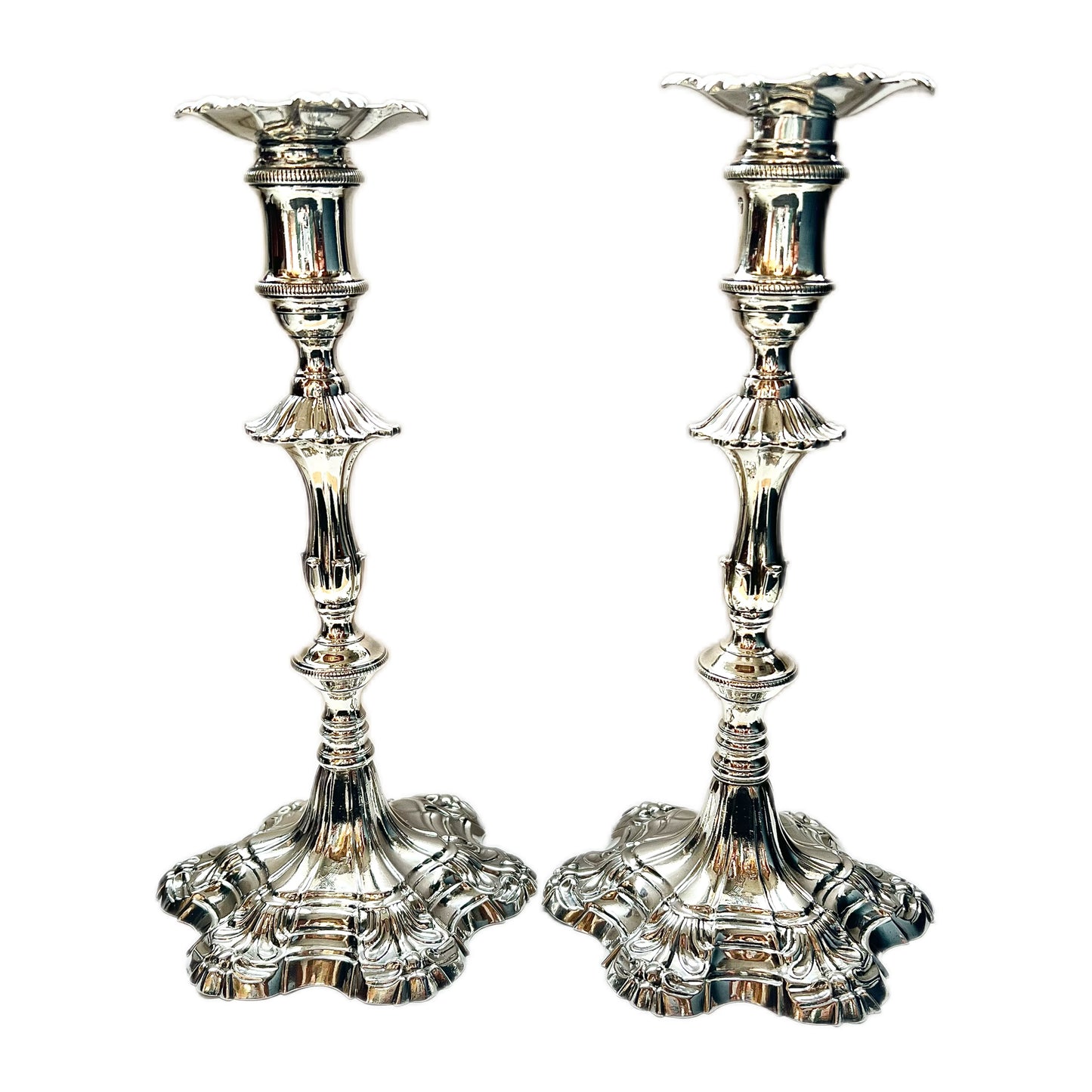 Pair of crested George III sterling silver cast candlesticks by William Cafe, London 1761 and 1762