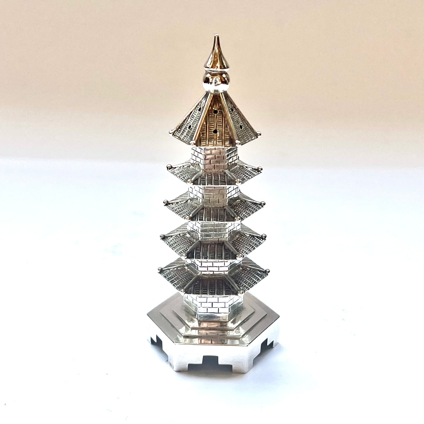 Early 20th century pagoda novelty form pepperette, marks for .900 silver and Wang Hing