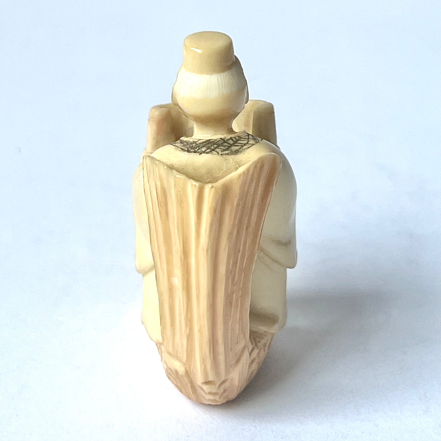Antique Japanese ivory netsuke of the Taoist immortal Kinko riding on a red carp