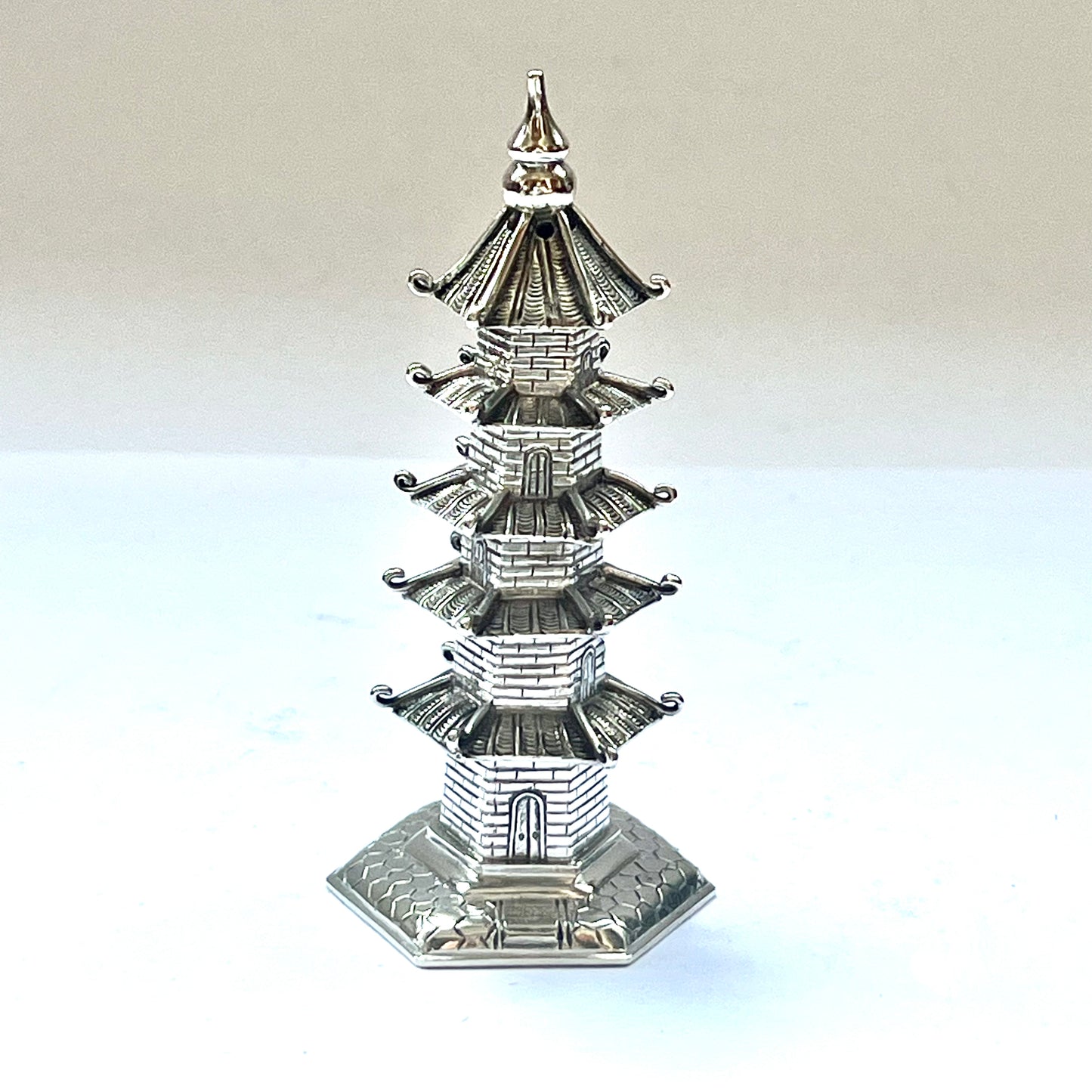 Early 20th century pagoda novelty form pepperette, marks for .900 silver and Wang Hing