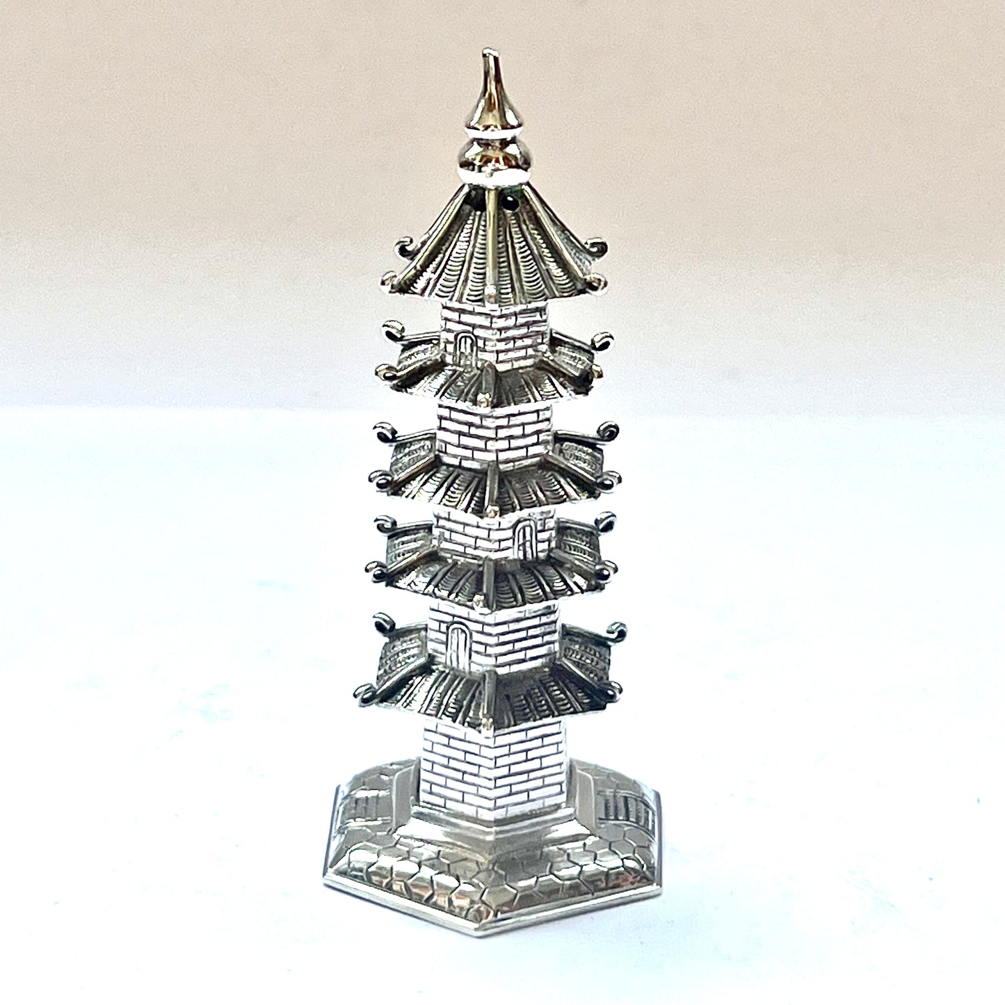Early 20th century pagoda novelty form pepperette, marks for .900 silver and Wang Hing