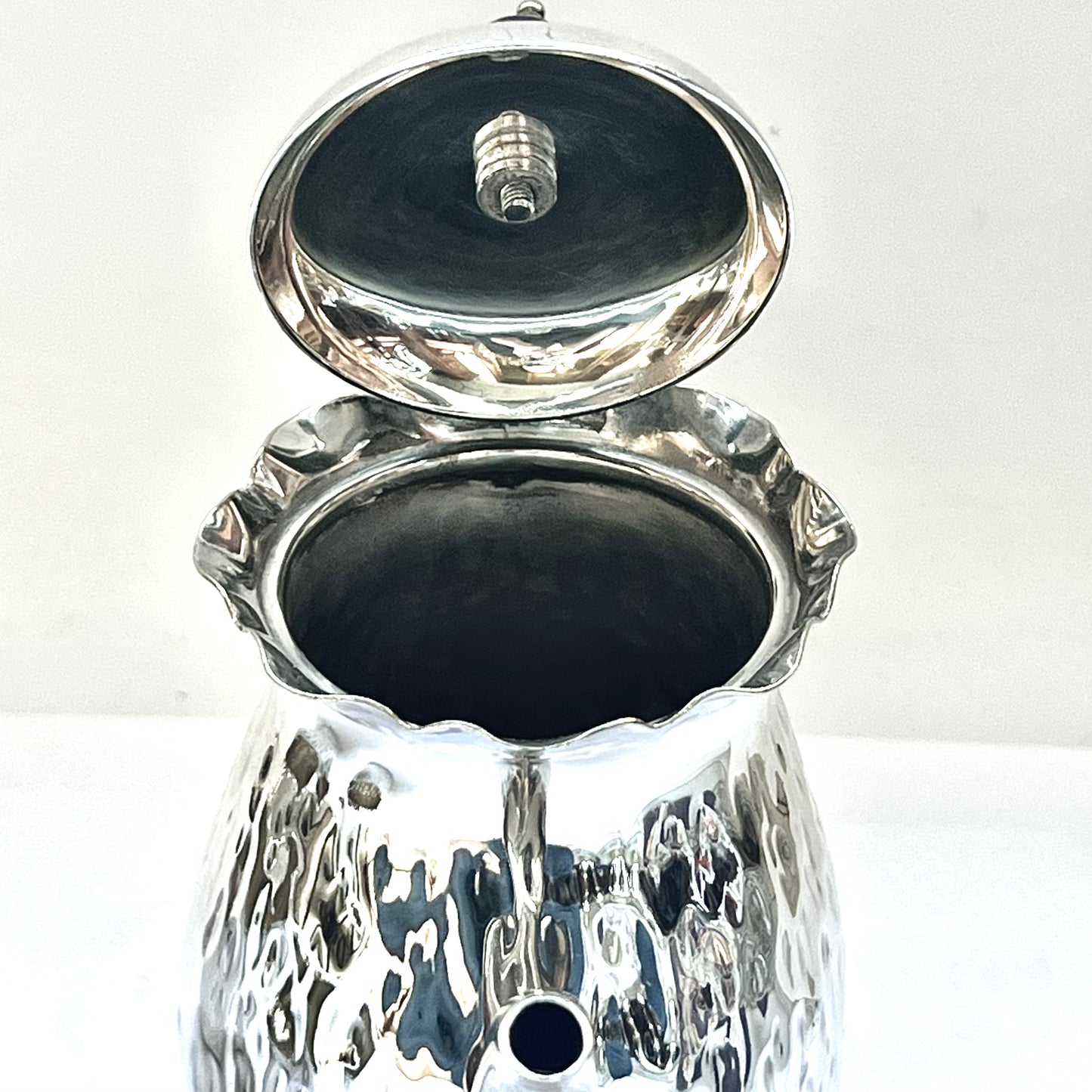 Antiguo juego de té de soltero bañado en plata, circa 1900, compuesto por una pequeña tetera, una jarra para leche, un azucarero y una taza de té.