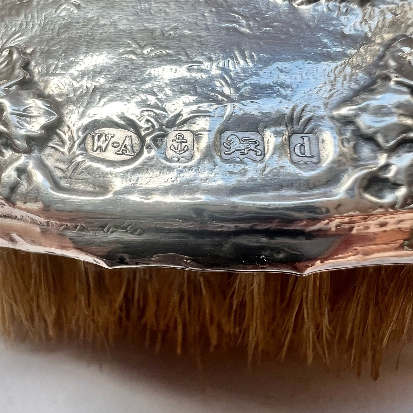 Beautiful antique English sterling silver hair brush with motifs of putti and grapes, William Aitken