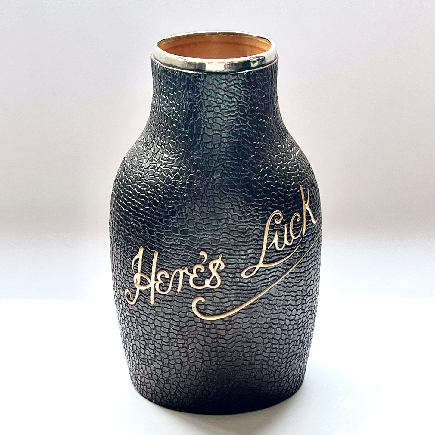 Victorian Doulton Lambeth Leather Ware Slaters blackjack jug with Sterling Silver Rim, marked for London, 1892, Cornelius Desormeaux Saunders & James Francis Hollings (Frank) Shepherd.