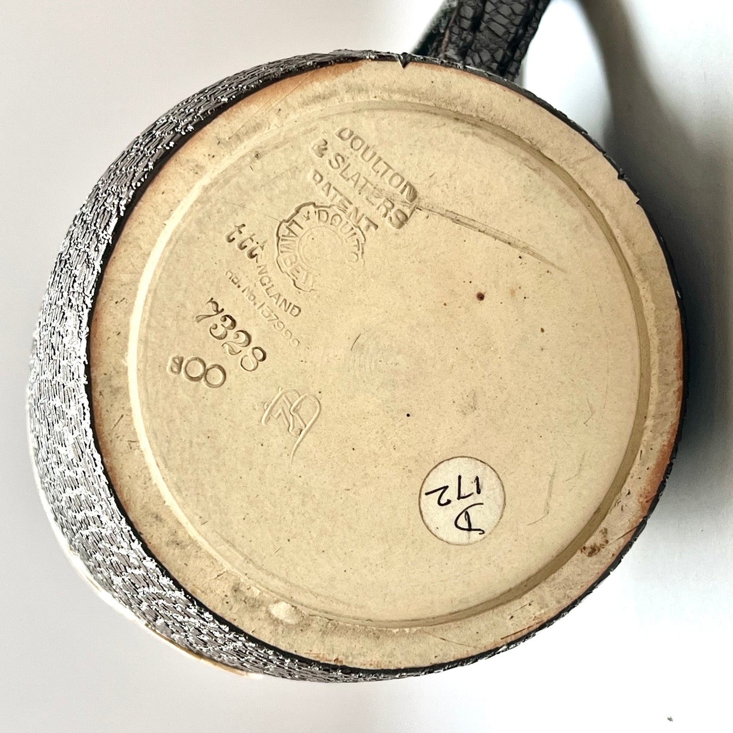 Victorian Doulton Lambeth Leather Ware Slaters blackjack jug with Sterling Silver Rim, marked for London, 1892, Cornelius Desormeaux Saunders & James Francis Hollings (Frank) Shepherd.