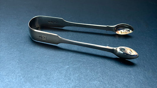 Late Georgian sterling silver tongs, crested, William Chawner II, London 1822.