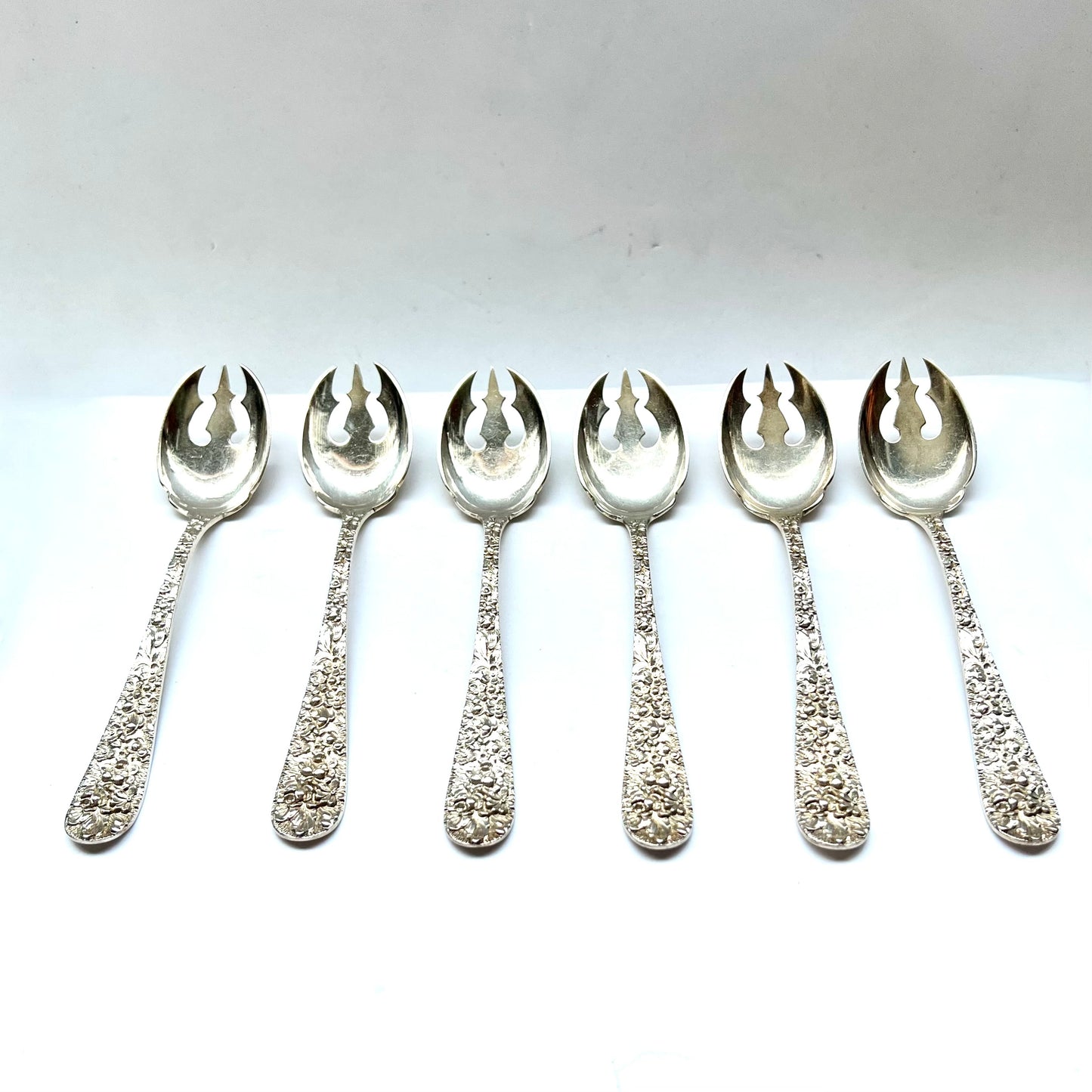 Vintage 1930s American sterling silver Rose Pattern ice cream spoons by Stieff of Baltimore, Maryland.