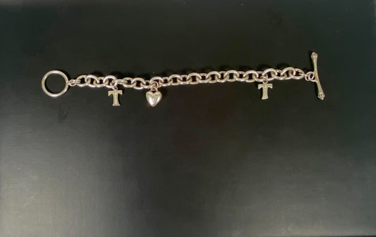 Vintage unmarked charm bracelet, tests silver, w 3 Tiffany & Co. hallmarked sterling silver charms