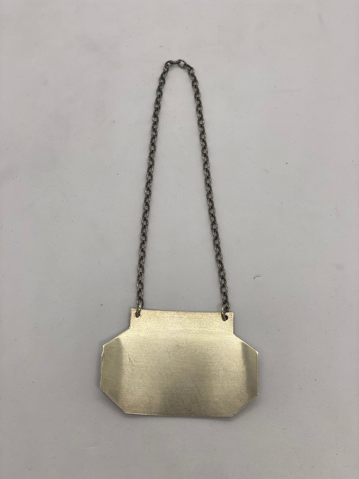 Etiqueta de licor de plata esterlina de 1979, de la colección personal de Sir John Atwill