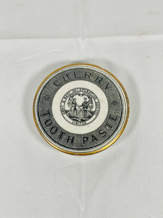 Tapa de bote de pasta de dientes con borde dorado, de la Sociedad Cooperativa del Ejército y la Marina, de cerámica victoriana de finales del siglo XIX, con diseño de cereza