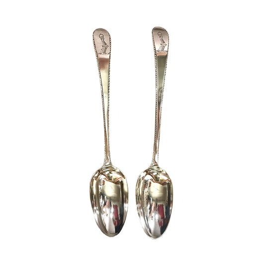 Matching pair of crested George III sterling silver serving spoons by Hester Bateman