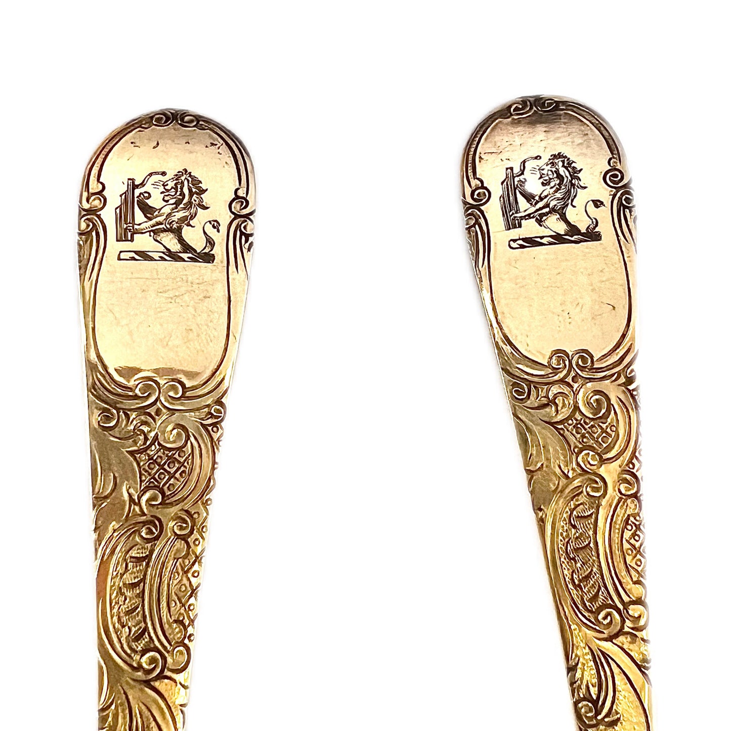 A cased pair of George III antique gilt sterling silver berry spoons, 1782, William Cattel