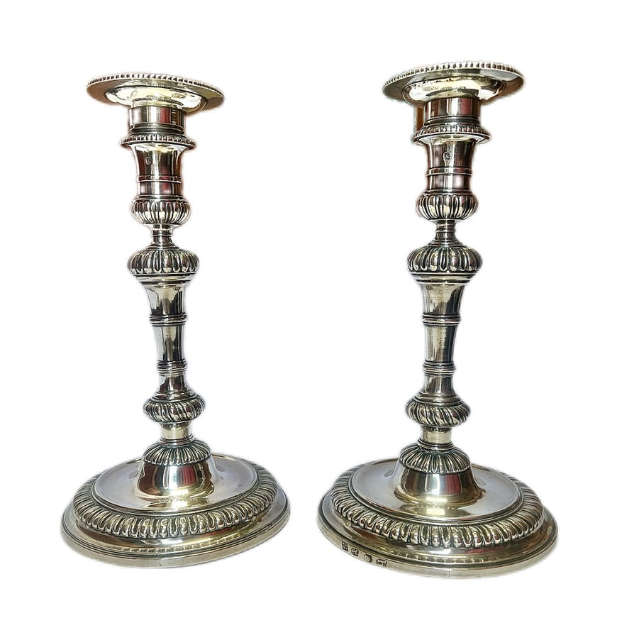 Crested pair of George II sterling silver candlesticks by Elizabeth Godfrey