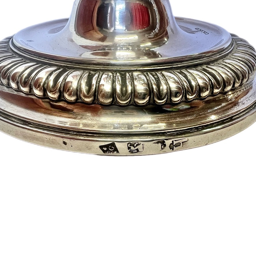 Crested pair of George II sterling silver candlesticks by Elizabeth Godfrey