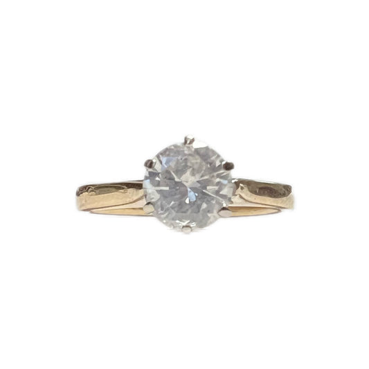 14 carat gold and round brilliant cut .08 carat diamond solitaire ring