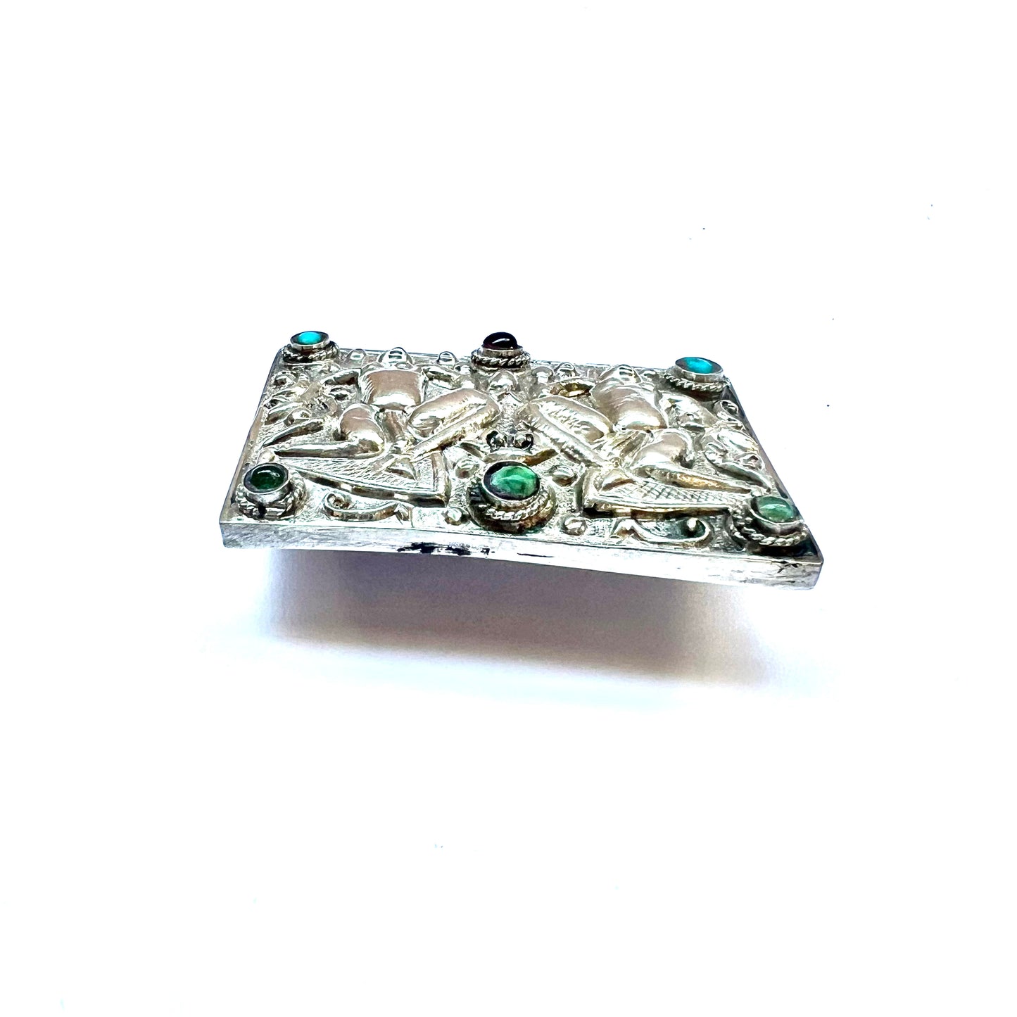 Antique Tibetan silver brooch with semi-precious stones and repousse deity motifs