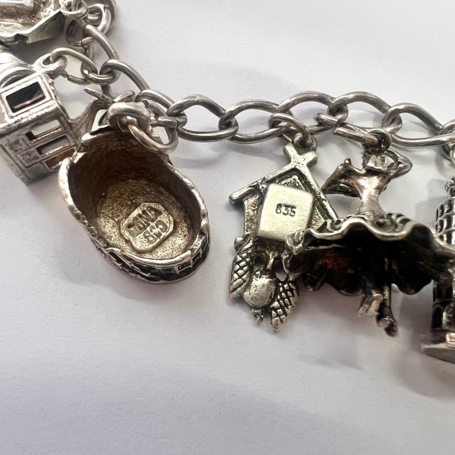 Vintage sterling silver bracelet with 20 attached silver charms