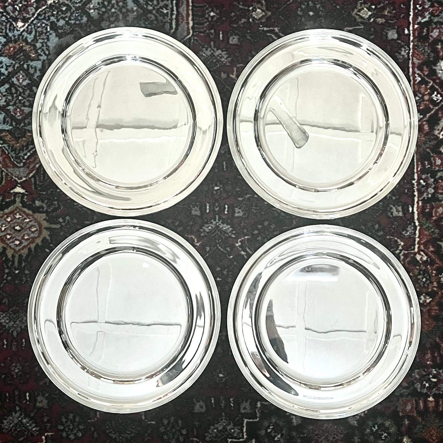 Set of 4 British Post-War Silver chargers, with marks for Nat Leslie, London, 1973.