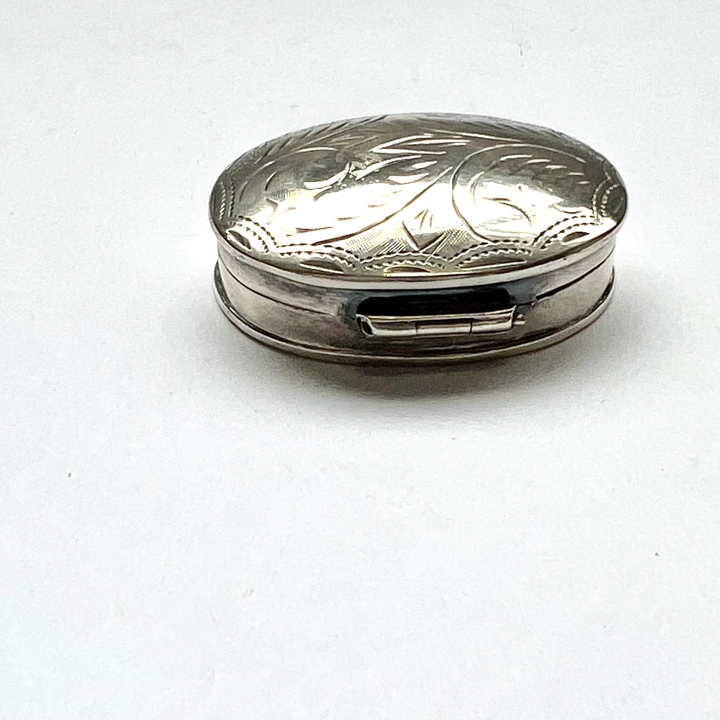 Vintage vintage oval sterling silver pillbox, foliate pattern. English import marks for Mark Houghton, Sheffield, 1993