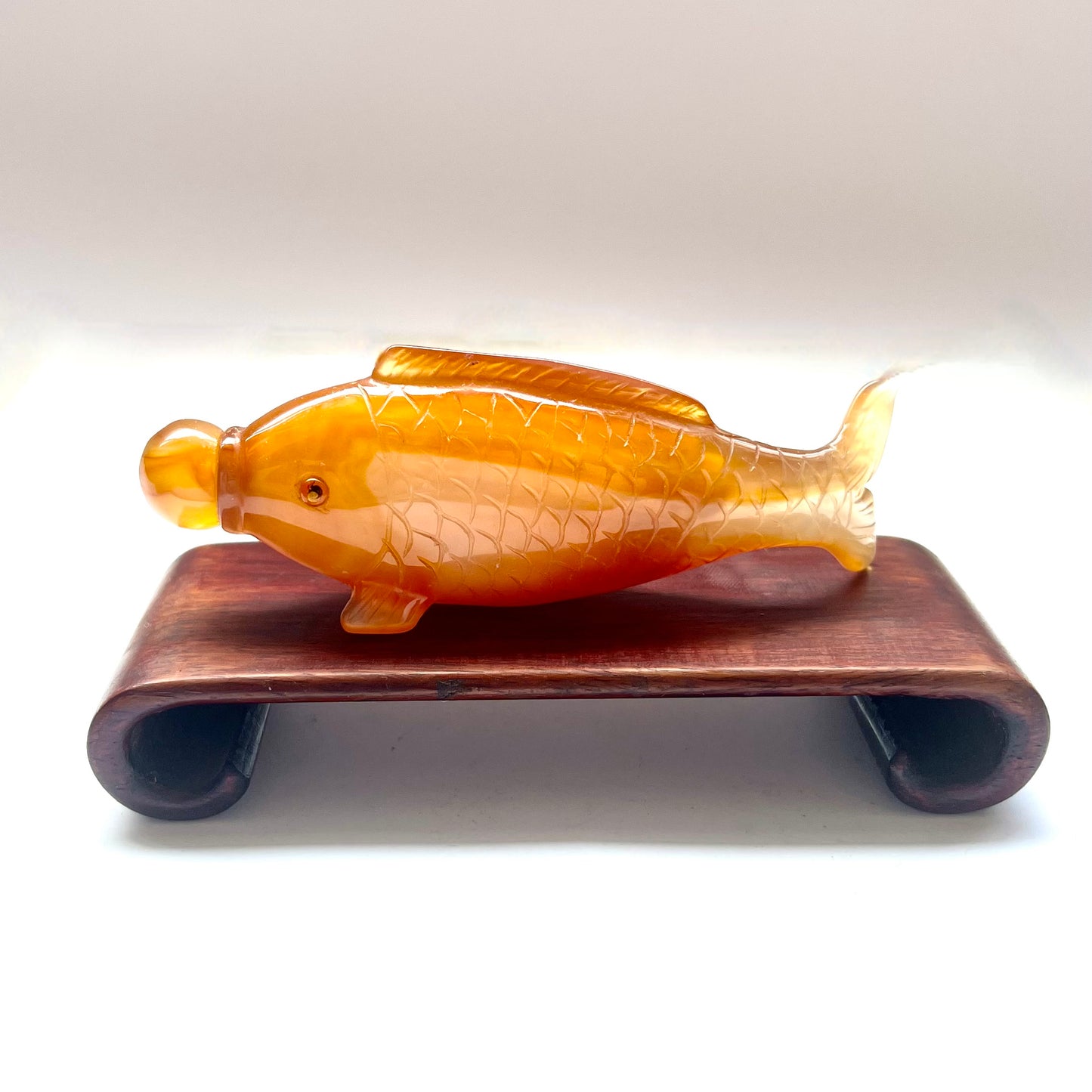 20th century Chinese orange-red agate fish-form snuff bottle