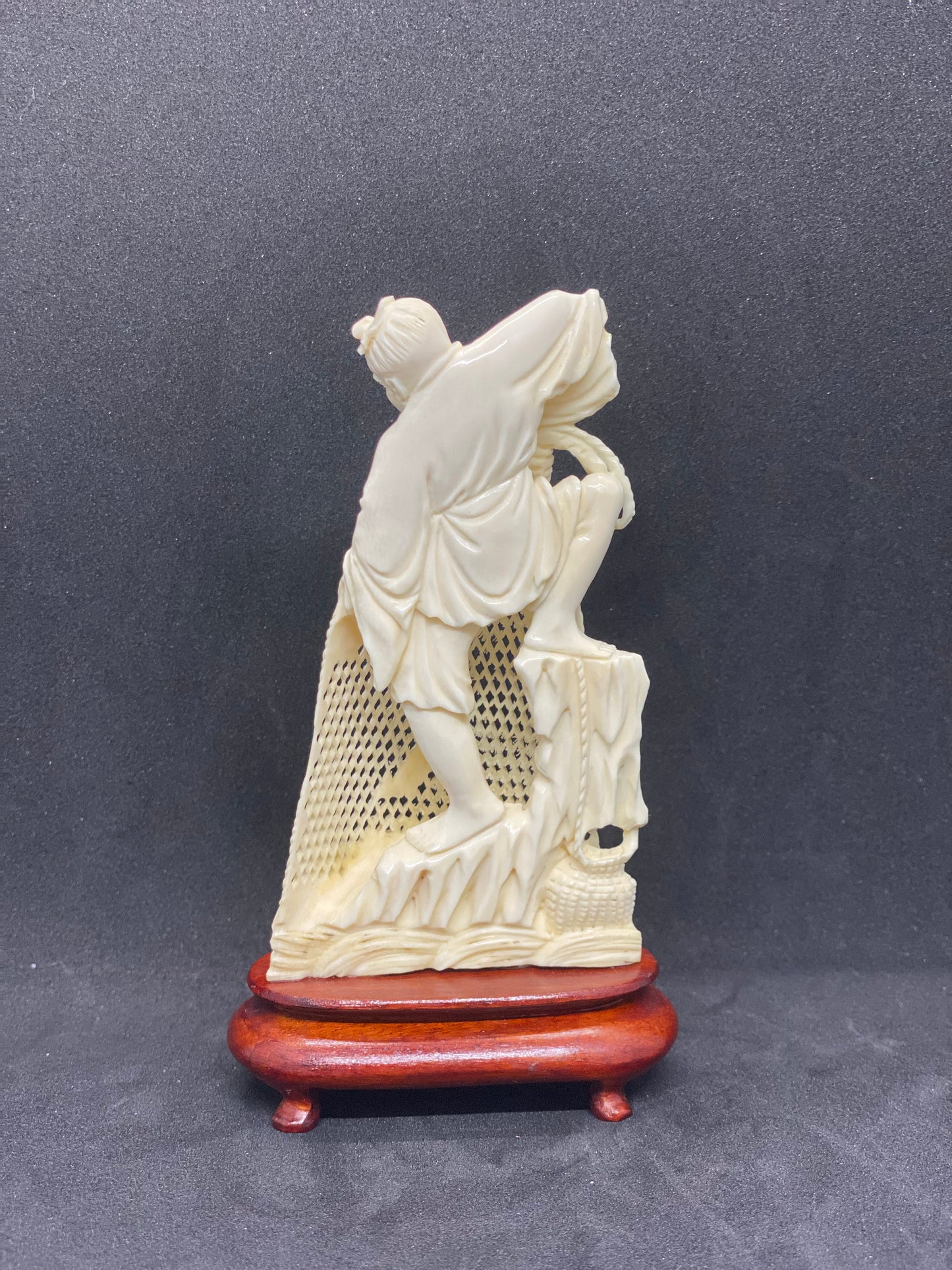 Small Ivory Figurine of Fisherman holding Net