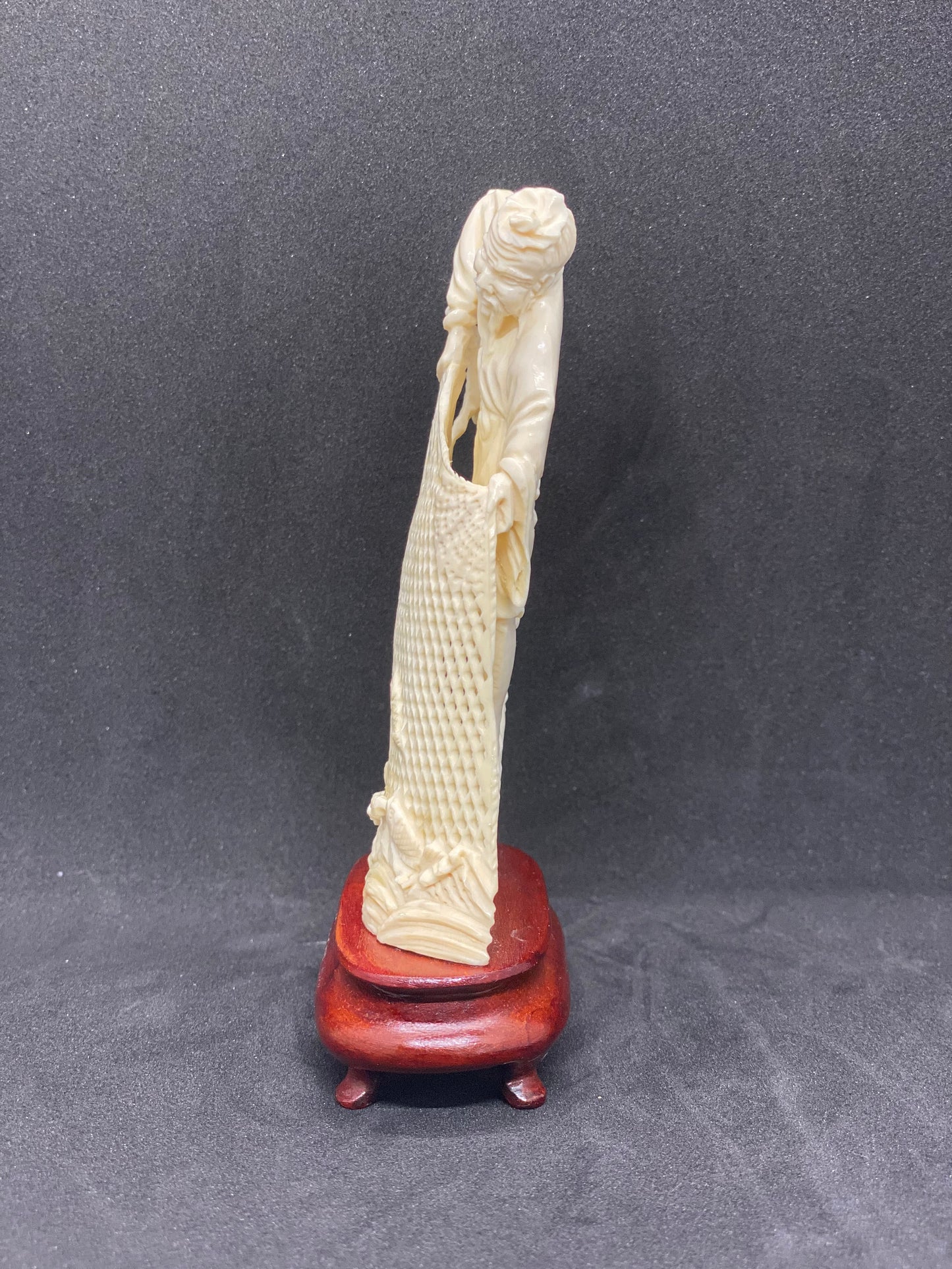 Small Ivory Figurine of Fisherman holding Net