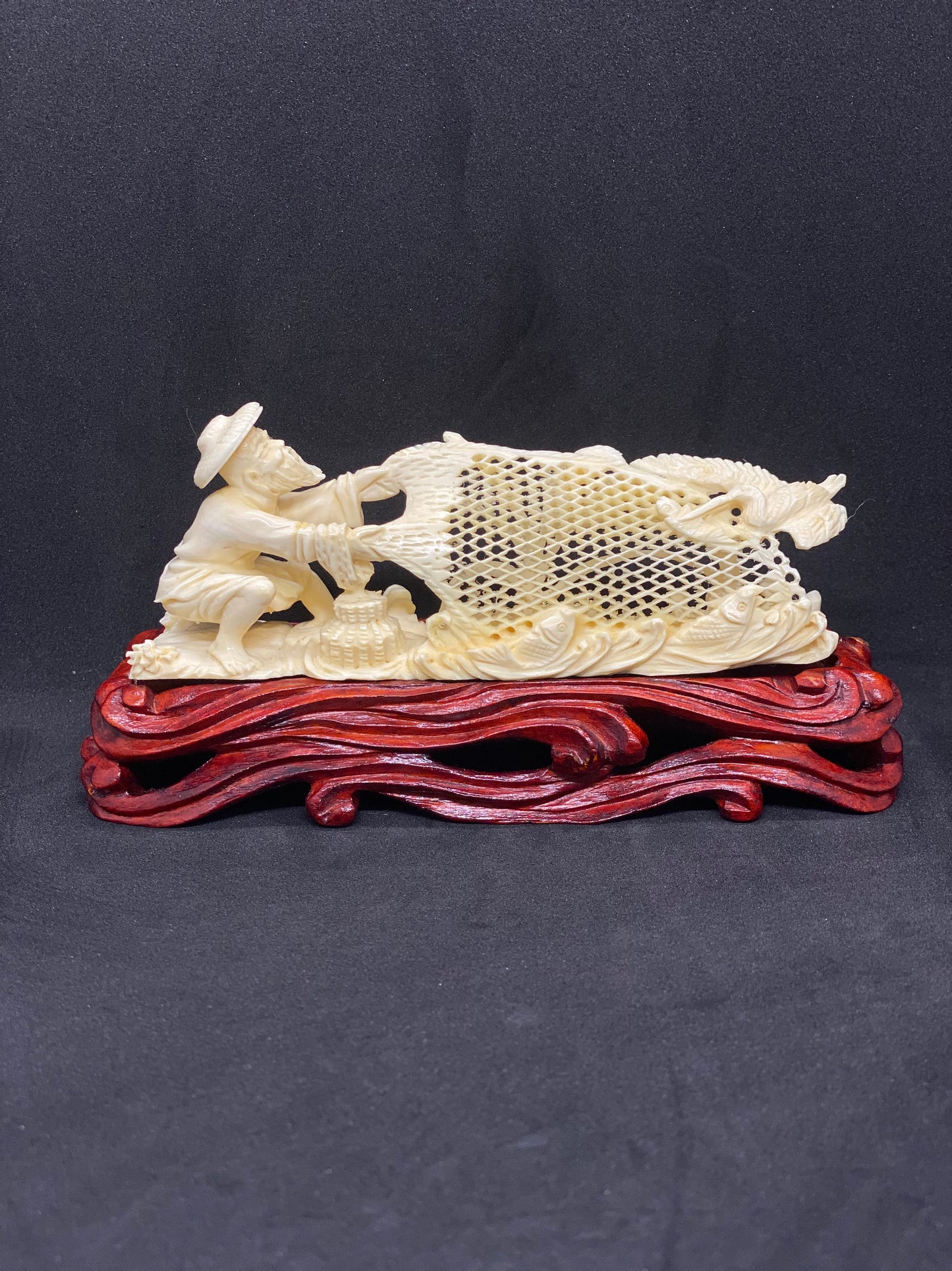 Small Ivory Figurine of Fisherman holding Net