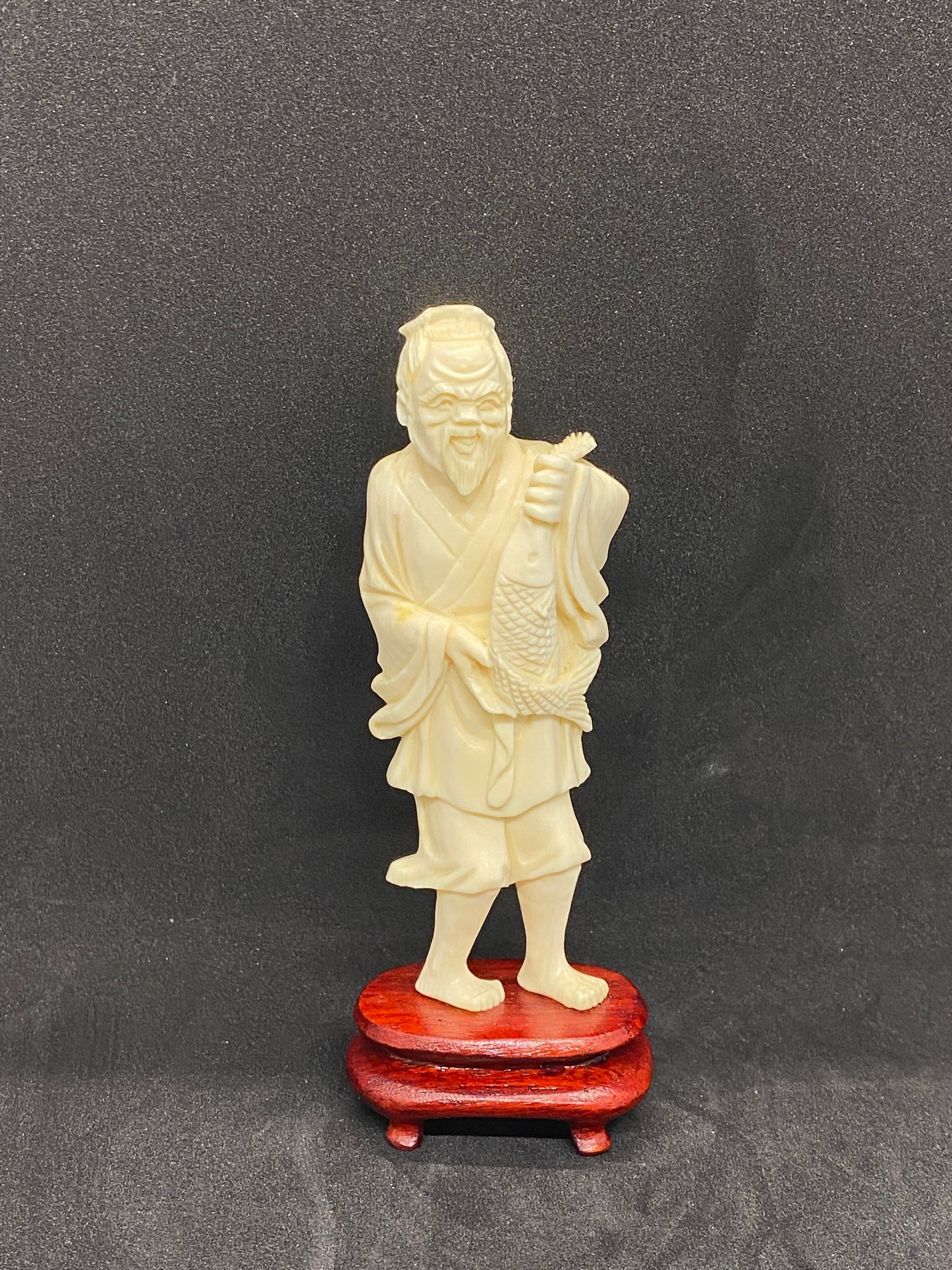 Antique Ivory Fisherman holding fish